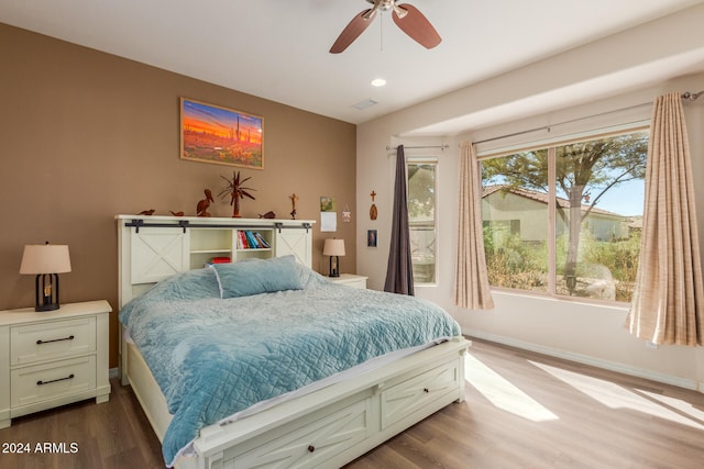 bedroom with light hardwood / wood-style floors and ceiling fan