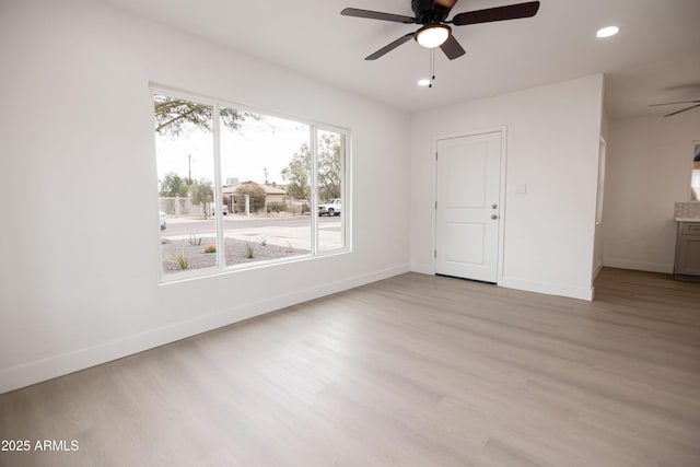 spare room with ceiling fan and light hardwood / wood-style flooring