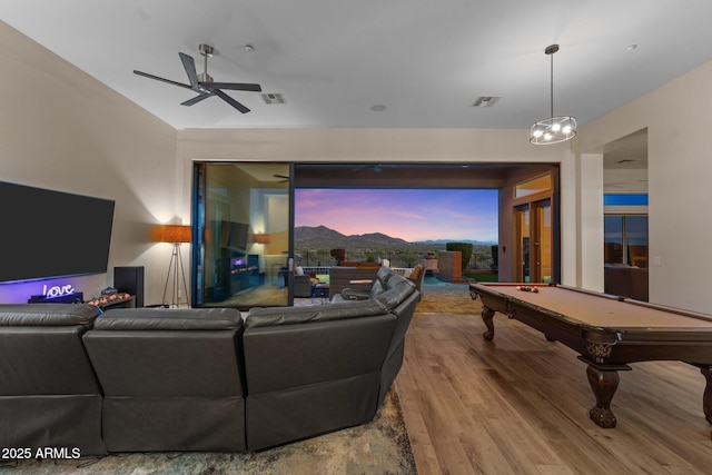 living room with hardwood / wood-style flooring, billiards, and ceiling fan