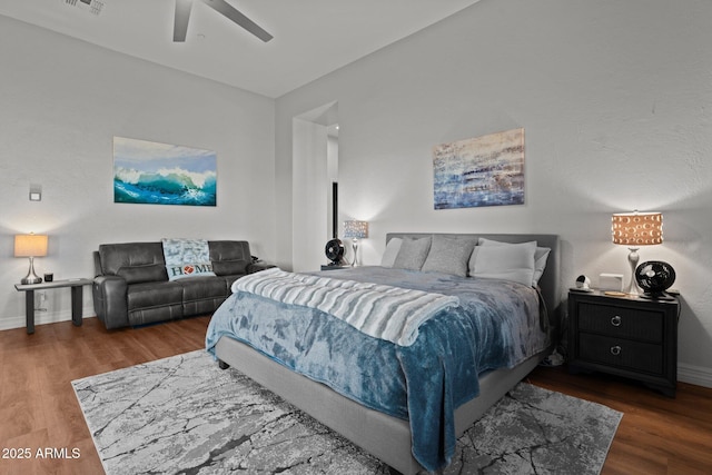 bedroom with ceiling fan, dark hardwood / wood-style floors, and lofted ceiling