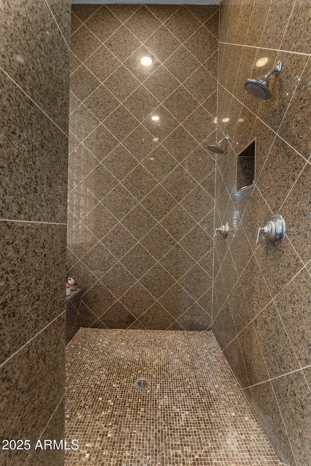 bathroom with tiled shower