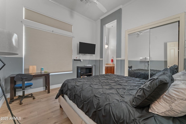 bedroom featuring ceiling fan, a closet, crown molding, and light hardwood / wood-style flooring