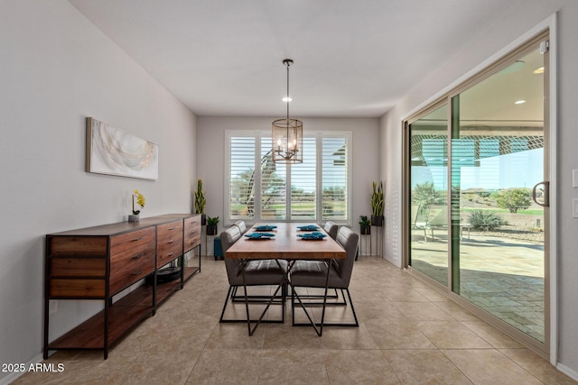 dining area featuring light tile patterned floors and a notable chandelier