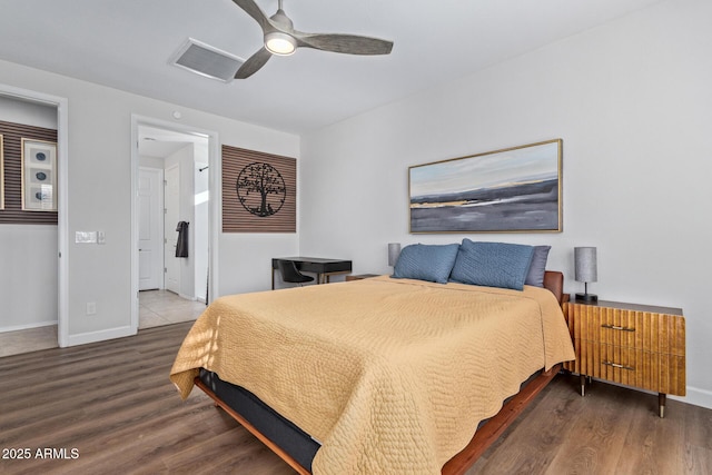 bedroom featuring ensuite bathroom, wood finished floors, a ceiling fan, visible vents, and baseboards