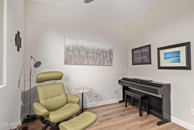 sitting room with baseboards and wood finished floors