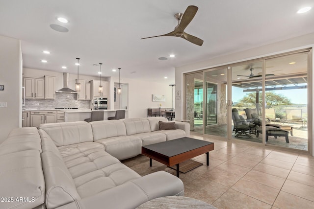 living room with a ceiling fan, recessed lighting, and light tile patterned floors