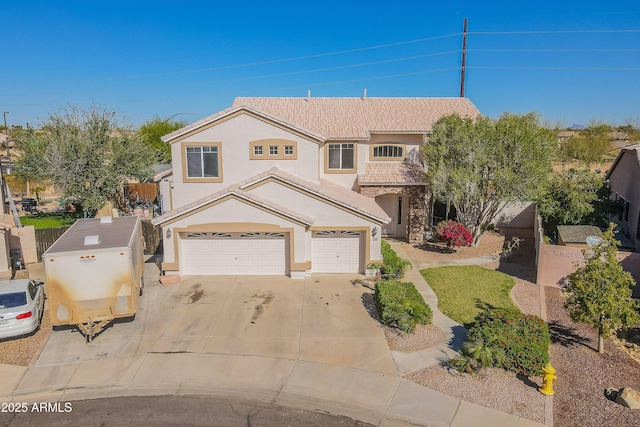 traditional-style home featuring stucco siding, a garage, driveway, and a tiled roof