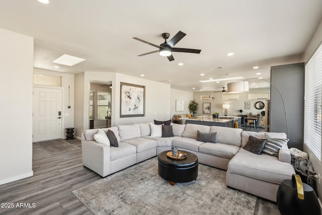 living room with ceiling fan, hardwood / wood-style flooring, and plenty of natural light