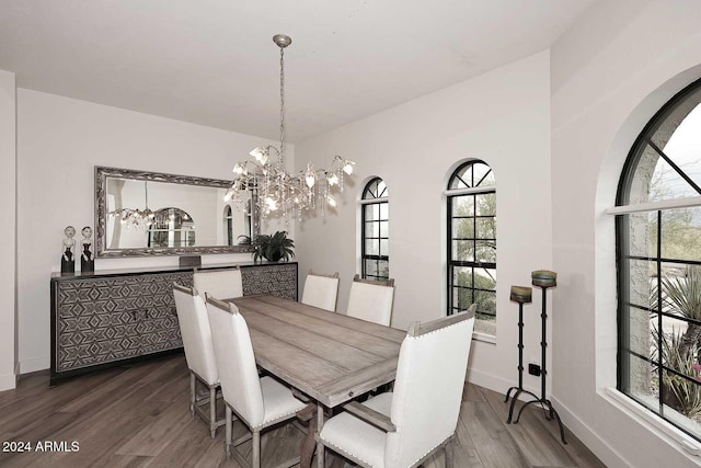 dining room featuring a notable chandelier and dark wood-type flooring