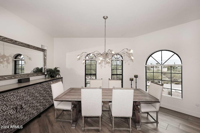 dining space featuring dark hardwood / wood-style floors, an inviting chandelier, and a healthy amount of sunlight