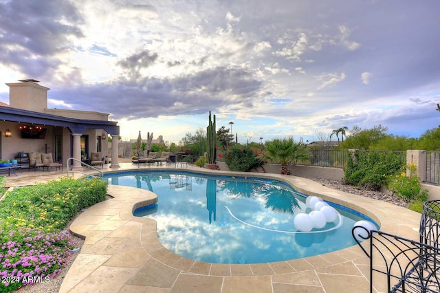 view of swimming pool with a patio area