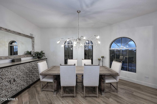 dining room featuring an inviting chandelier and dark wood-type flooring