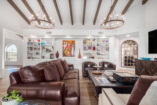 living room with hardwood / wood-style floors, high vaulted ceiling, and a notable chandelier