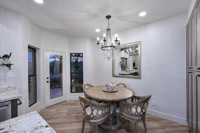 dining space with a chandelier and light wood-type flooring