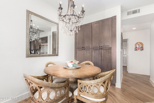 dining space with hardwood / wood-style floors