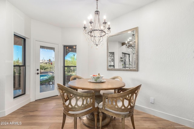 dining area featuring a notable chandelier and light wood-type flooring