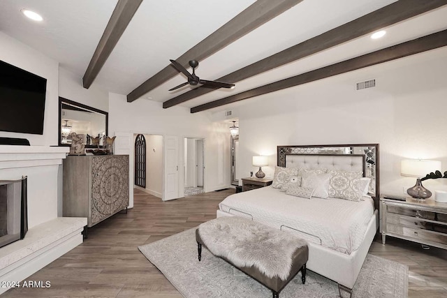 bedroom featuring beam ceiling, ceiling fan, and hardwood / wood-style floors