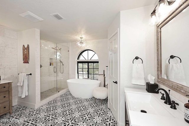 bathroom featuring tile patterned flooring, vanity, independent shower and bath, and a notable chandelier