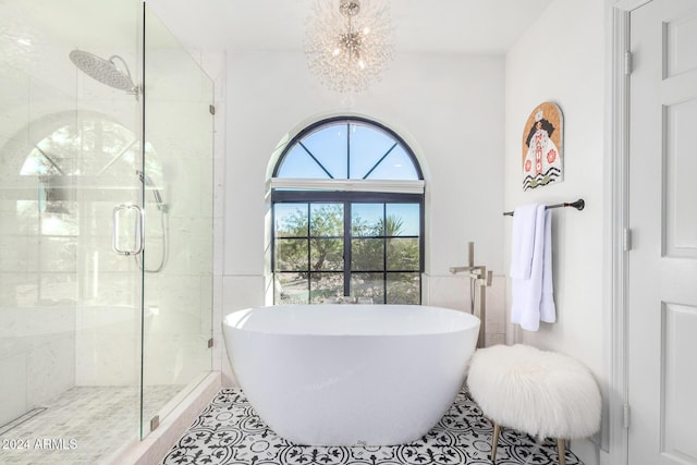 bathroom with tile patterned flooring, a notable chandelier, and independent shower and bath