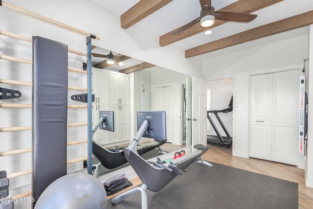 exercise room featuring ceiling fan, light hardwood / wood-style flooring, and vaulted ceiling