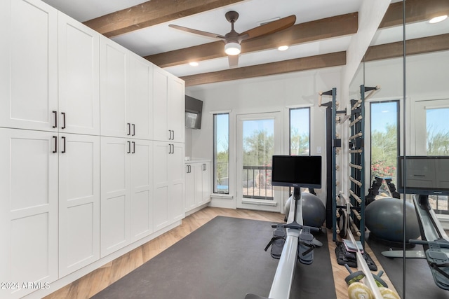 exercise room with light hardwood / wood-style flooring, ceiling fan, and a healthy amount of sunlight