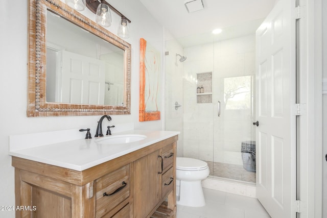 bathroom with tile patterned flooring, vanity, toilet, and a shower with shower door