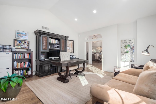 office area with light hardwood / wood-style floors and high vaulted ceiling