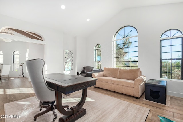 office area featuring light wood-type flooring and high vaulted ceiling