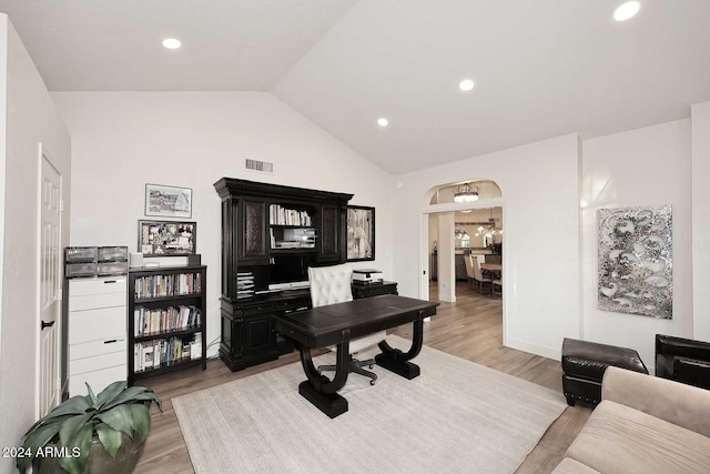 office featuring light hardwood / wood-style floors and lofted ceiling