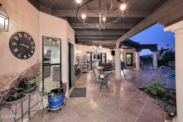 patio terrace at dusk featuring outdoor lounge area