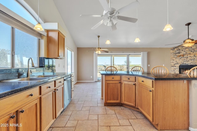 kitchen with hanging light fixtures, lofted ceiling, sink, and stainless steel dishwasher