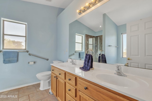 bathroom with a shower with door, vanity, a wealth of natural light, and toilet