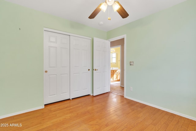 unfurnished bedroom with ceiling fan, a closet, and light wood-type flooring