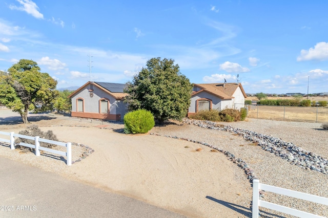 view of front of home with a rural view