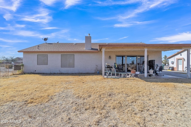 back of property with a patio and a lawn