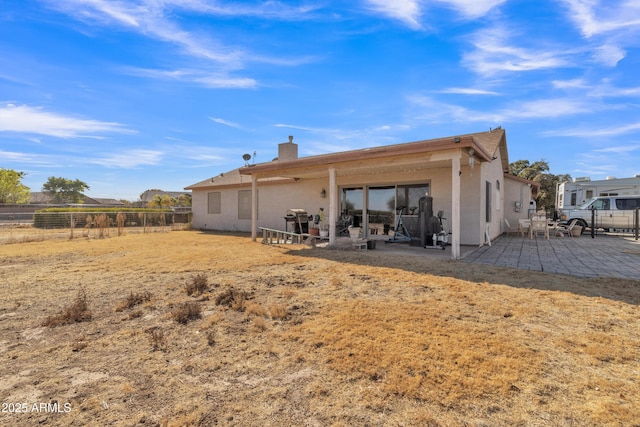 back of property featuring a patio