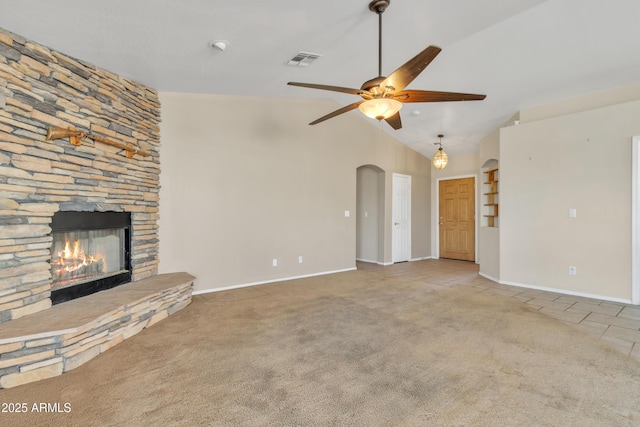 unfurnished living room with ceiling fan, high vaulted ceiling, light colored carpet, and a fireplace