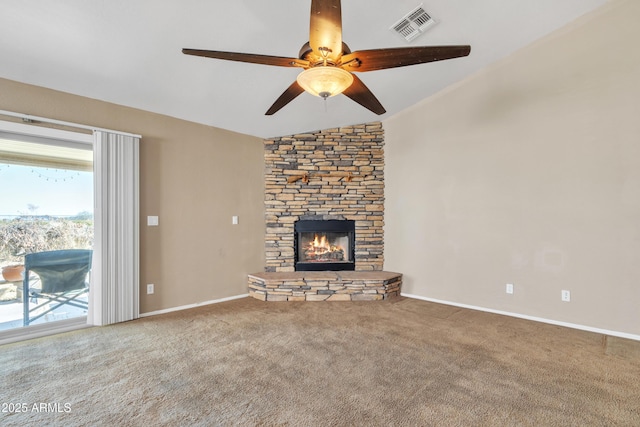 unfurnished living room with ceiling fan, lofted ceiling, carpet, and a fireplace