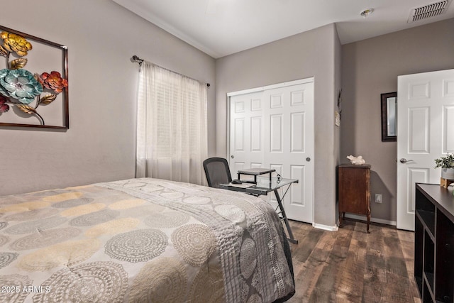 bedroom with visible vents, baseboards, a closet, and dark wood finished floors