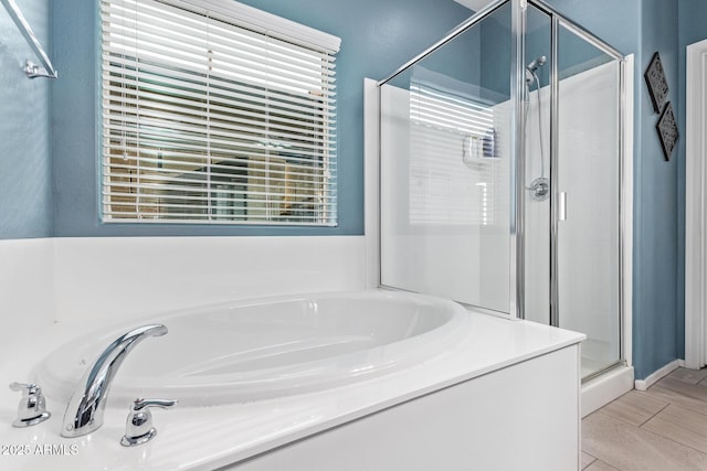 bathroom featuring a garden tub and a stall shower