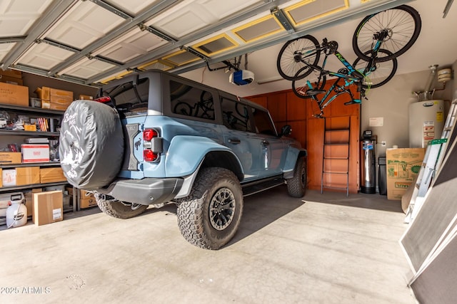 garage featuring water heater and a garage door opener