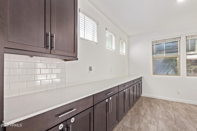 1081 E Armstrong Way, Chandler, AZ 85286 - kitchen with dark brown cabinetry, light countertops, and baseboards