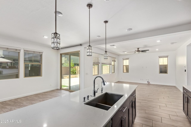 1081 E Armstrong Way, Chandler, AZ 85286 - kitchen with a sink, light wood finished floors, hanging light fixtures, open floor plan, and recessed lighting