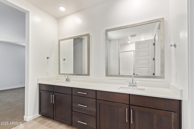1081 E Armstrong Way, Chandler, AZ 85286 - full bath with double vanity, baseboards, and wood finished floors