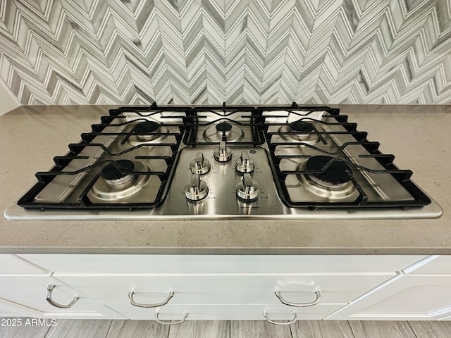 room details with tasteful backsplash and stainless steel gas stovetop