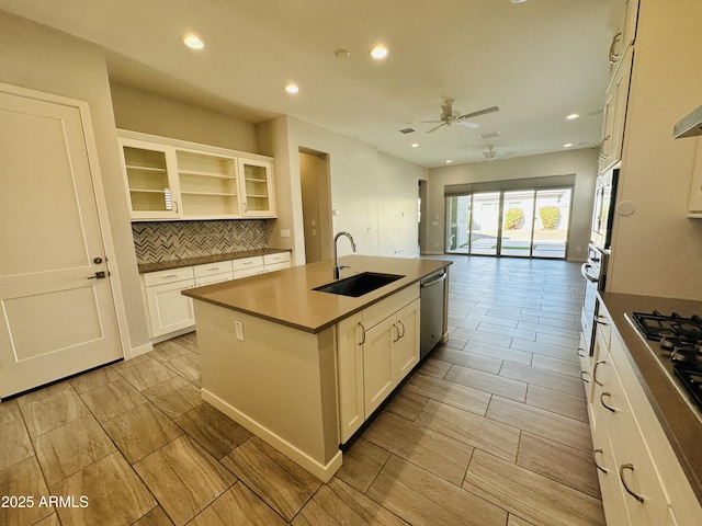 kitchen with white cabinetry, sink, appliances with stainless steel finishes, and a center island with sink