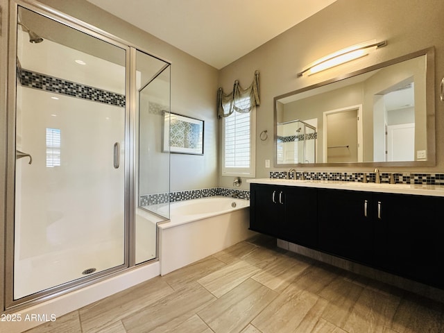 bathroom with independent shower and bath and vanity