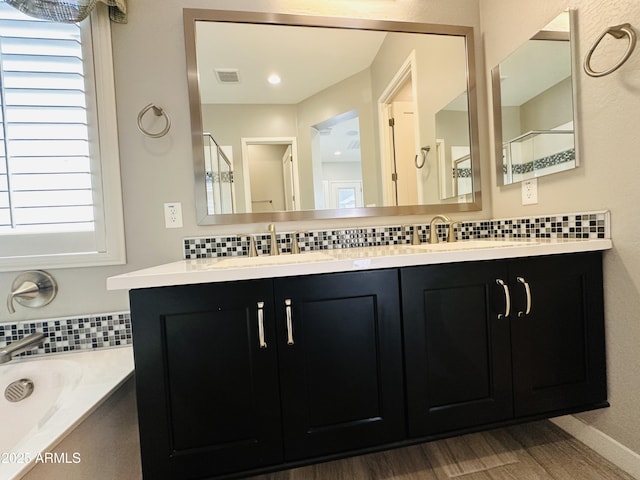 bathroom with tasteful backsplash, vanity, shower with separate bathtub, and wood-type flooring