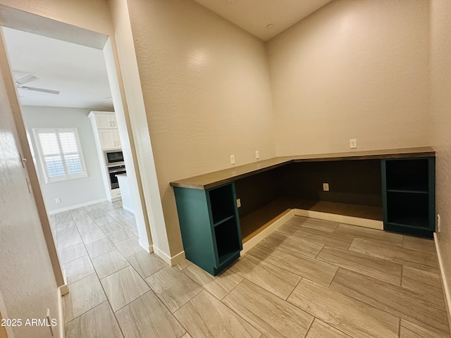 unfurnished office featuring ceiling fan