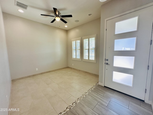 entrance foyer with ceiling fan